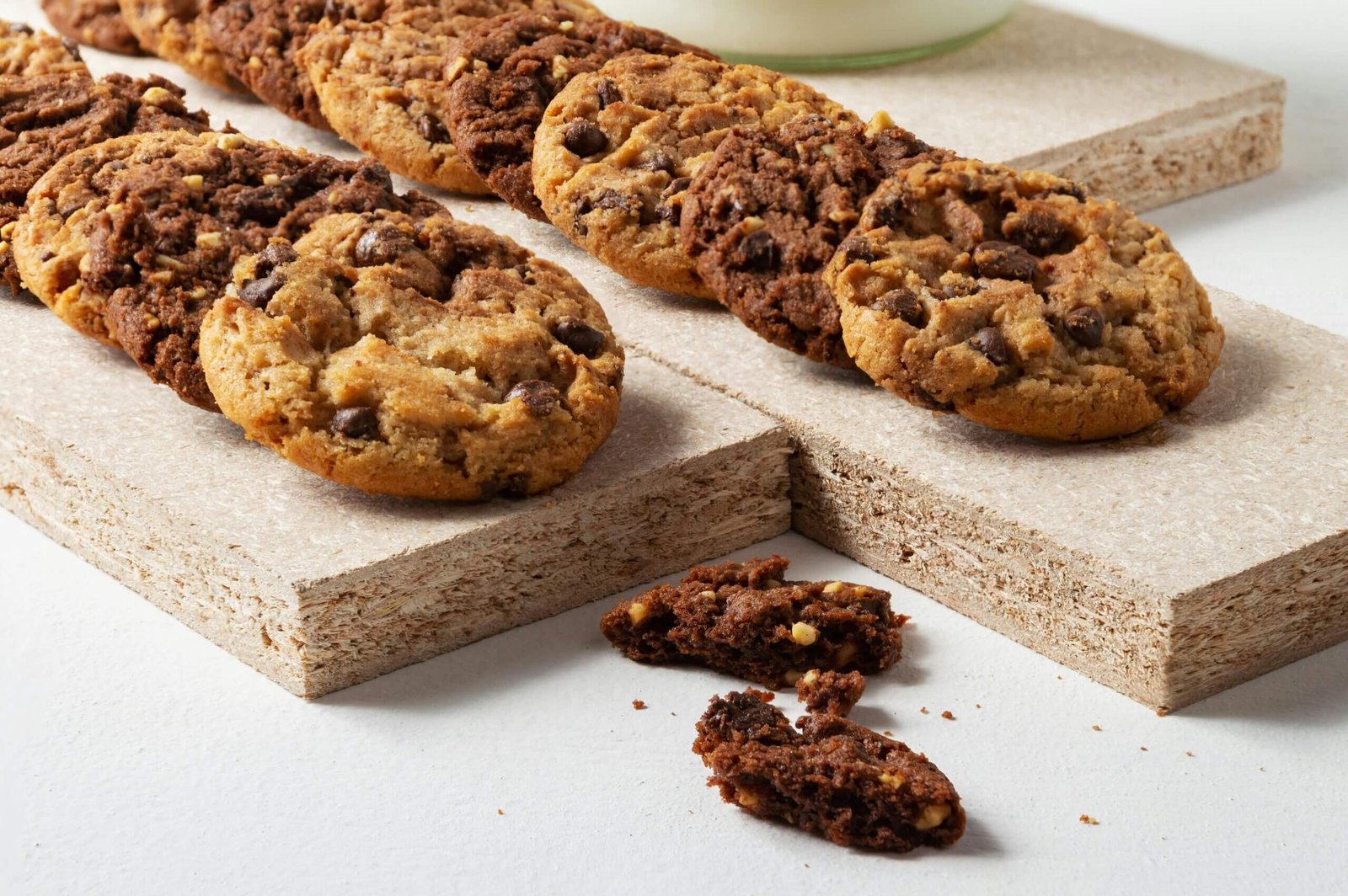 Close-up of assorted chocolate chip cookies on a wooden board, perfect for snacking.